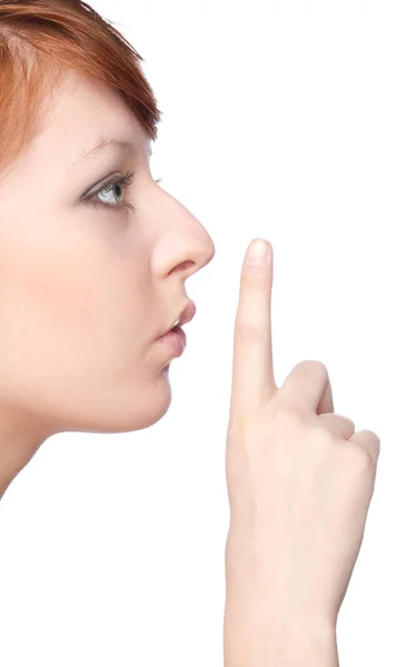 Een meisje heeft een vinger op de lippen gebaar stil — Stockfoto