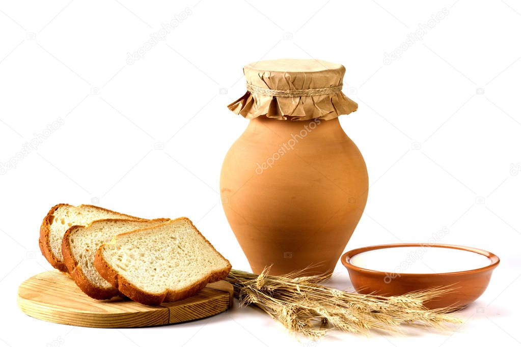 Baking bread and jug with milk