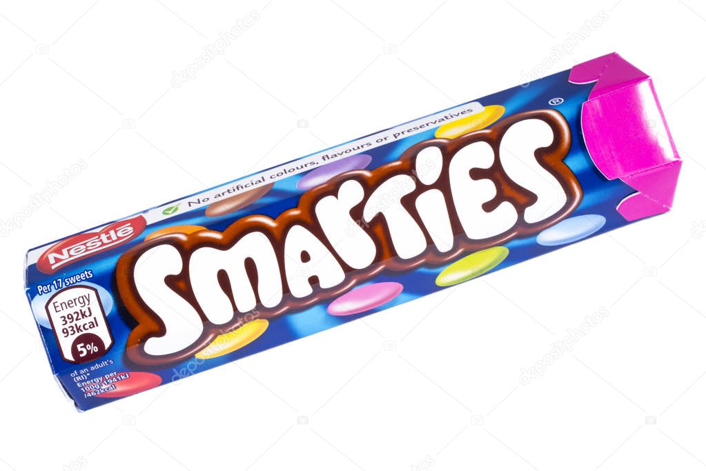 LONDON, UK - OCTOBER 13TH 2016: An unopened Smarties chocolate sweets tube manufactured by Nestle, pictured over a plain white background on 13th October 2016.
