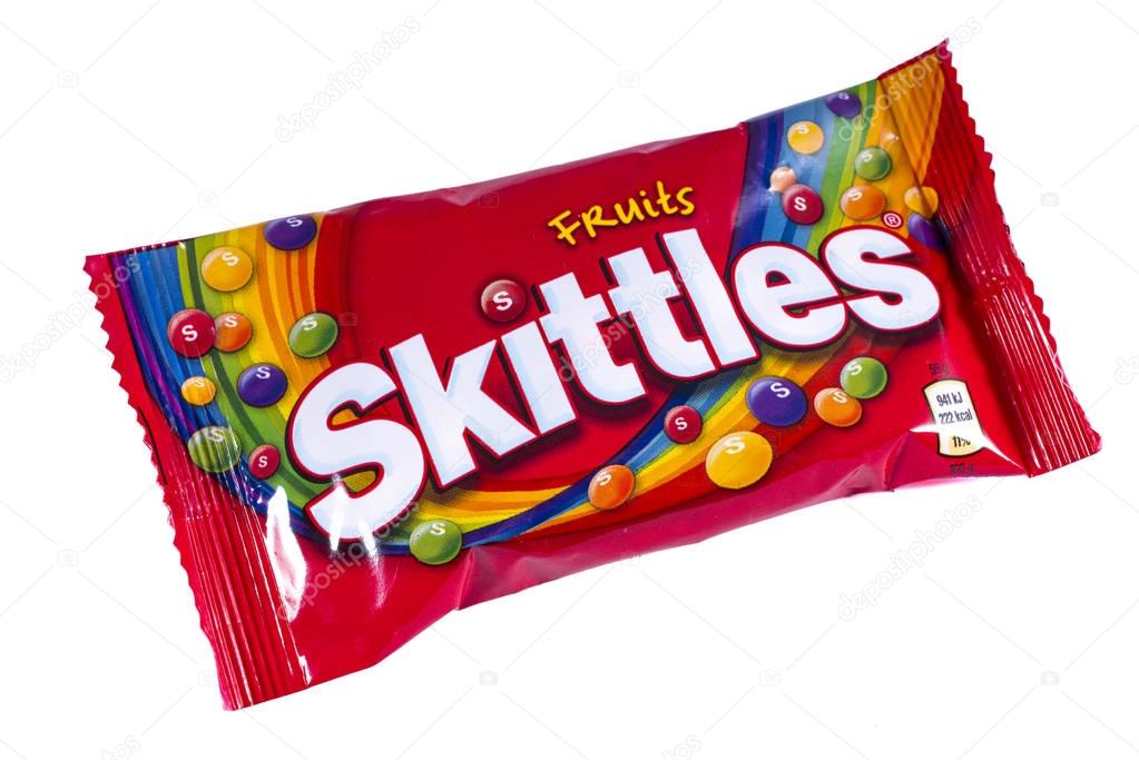 LONDON, UK - OCTOBER 13TH 2016: An unopened pack of Fruit Skittles over a plain white background, on 13th October 2016.  The Skittles sweets brand is owned and produced by the Wrigley Company.