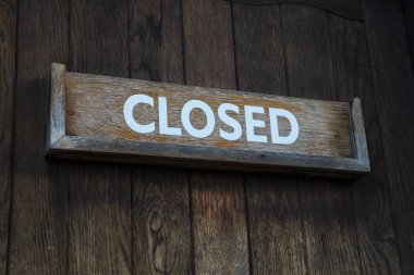 Closed Sign on a Wooden Door clipart