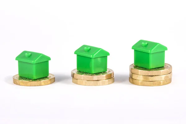 Green Houses Sitting on Top of Coins — Stock Photo, Image