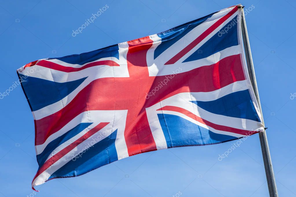 A Union Flag flying proudly under a clear blue sky.