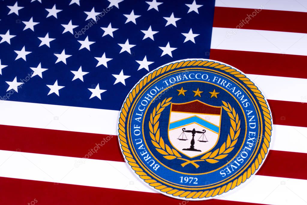 LONDON, UK - MARCH 26TH 2018: The seal or symbol of the Bureau of Alcohol, Tobacco, Firearms and Explosives, portrayed with the US flag, on 26th March 2018.