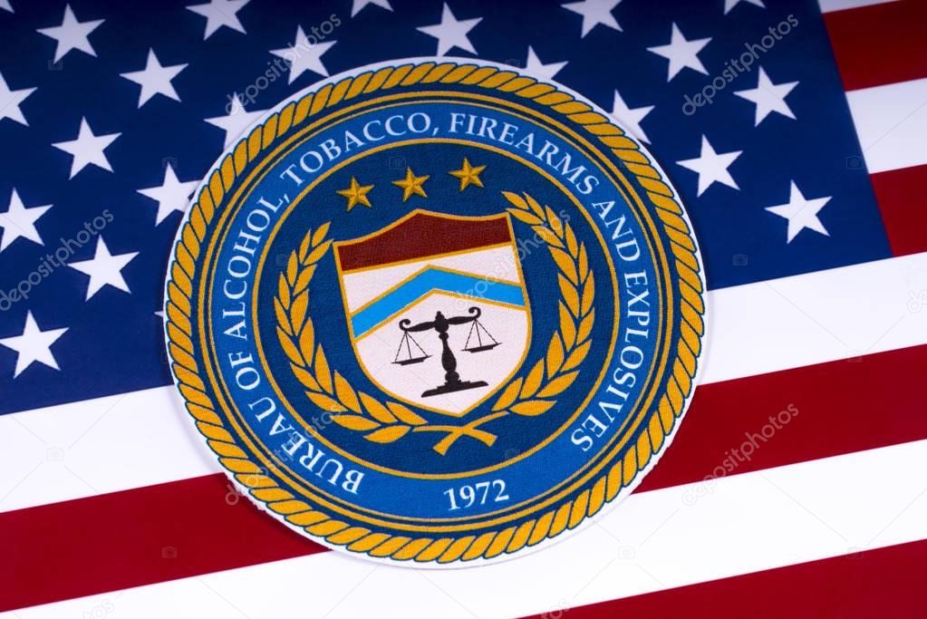 LONDON, UK - MARCH 26TH 2018: The seal or symbol of the Bureau of Alcohol, Tobacco, Firearms and Explosives, portrayed with the US flag, on 26th March 2018.