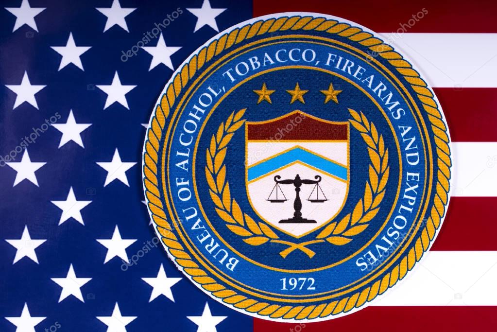 LONDON, UK - MARCH 26TH 2018: The seal or symbol of the Bureau of Alcohol, Tobacco, Firearms and Explosives, portrayed with the US flag, on 26th March 2018.