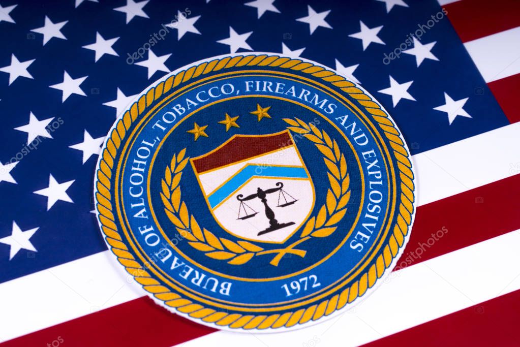 LONDON, UK - MARCH 26TH 2018: The seal or symbol of the Bureau of Alcohol, Tobacco, Firearms and Explosives, portrayed with the US flag, on 26th March 2018.