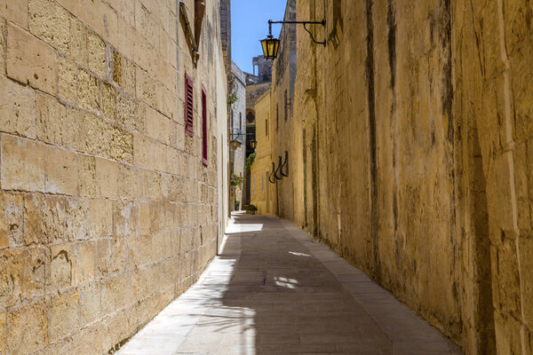 A view down one of the pretty narrow streets in the historic city of Mdina in Malta.