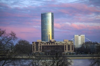 Cologne, Germany - February 17th 2020: View across the Rhine towards the KolnTriangle - a 339 ft tall building with the top floor and roof housing an observation deck offering panoramic views of Cologne in Germany.
