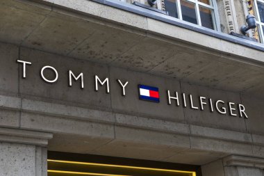 Dusseldorf, Germany - February 18th 2020: The Tommy Hilfiger logo above the entrance to one of their stores in the city of Dusseldorf in Germany. clipart
