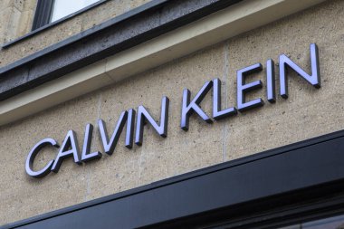 Dusseldorf, Germany - February 18th 2020: The Calvin Klein logo above the entrance to one of their stores in the city of Dusseldorf in Germany. clipart