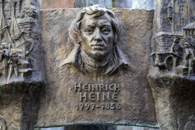 Dusseldorf, Germany - February 18th 2020: A sculpture of historic German writer and poet Heinrich Heine on the Heimatbrunnen, or Home Fountain, in the city of Dusseldorf, Germany.
