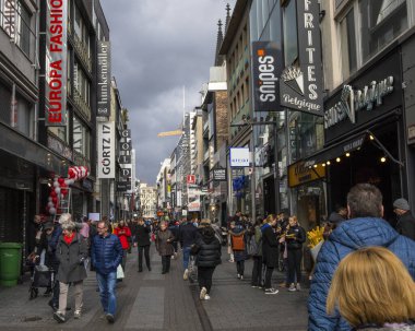 Cologne, Germany - February 19th 2020: Looking up Hohe Strasse - one of the main shopping streets in the city of Cologne in Germany.