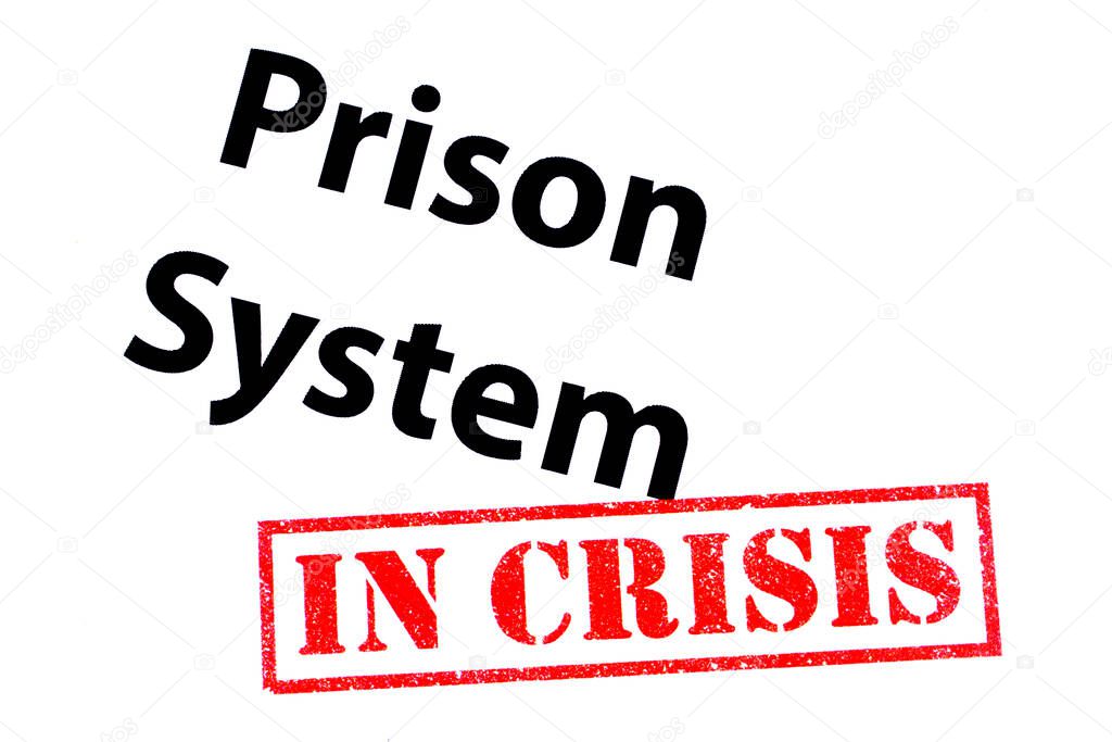 Prison System heading with a red IN CRISIS rubber stamp