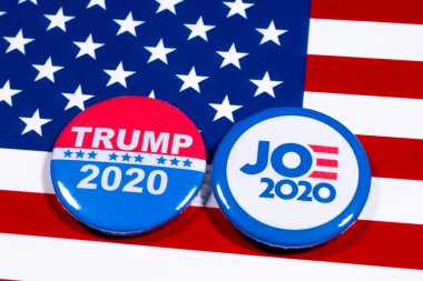 London, UK - May 5th 2020: Donald Trump and Joe Biden pin badges, pictured of the USA flag.  The two men will be battling eachother in the 2020 US Presidential Election. clipart
