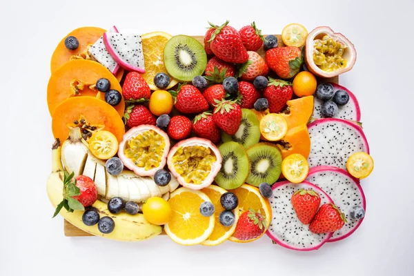 Fresh fruits. Exotic fresh fruits on a blackboard. Strawberry, blueberry, papaya, dragon fruit, kiwi, passion fruit.
