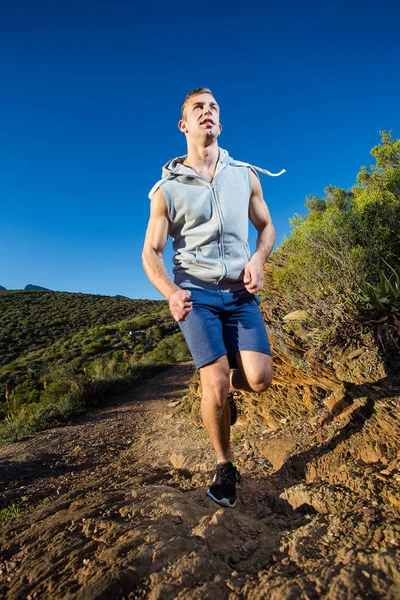 Male fitness model running along a trail — Stock Photo, Image