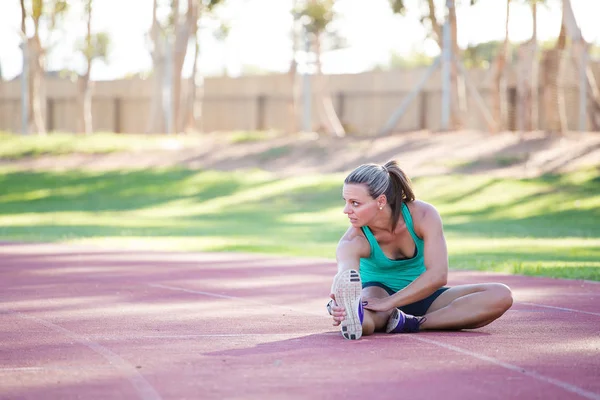 female athlete doing stretches