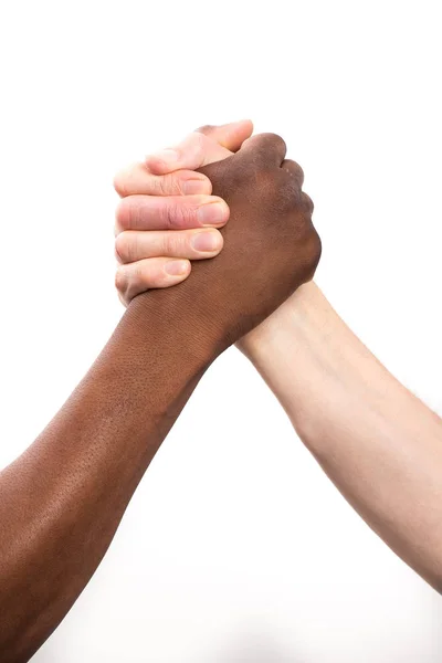 Caucasian human gripping a african human hand — Stock Photo, Image