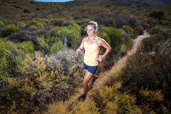Triatleta feminina correndo em uma trilha — Fotografia de Stock