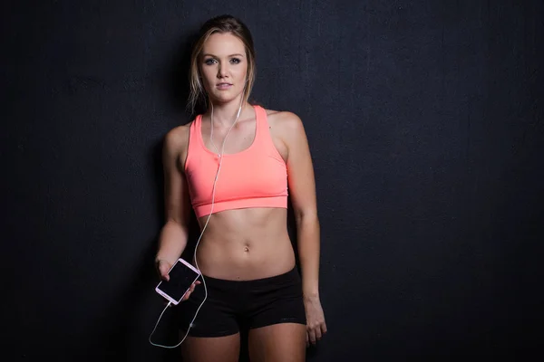 Fitness model met smartphone — Stockfoto