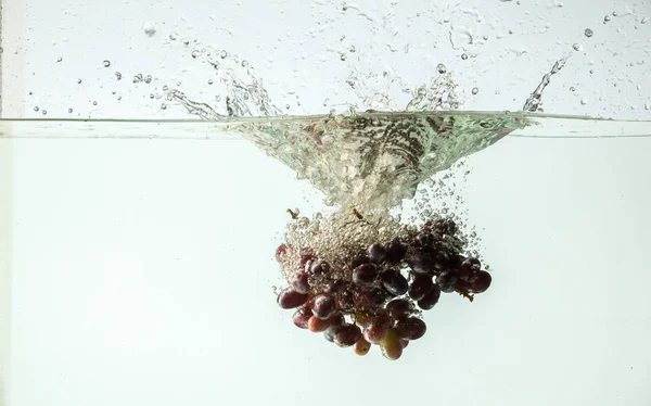 Red grapes in water