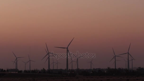 Větrné farmy, jak je vidět z dálky za soumraku — Stock video