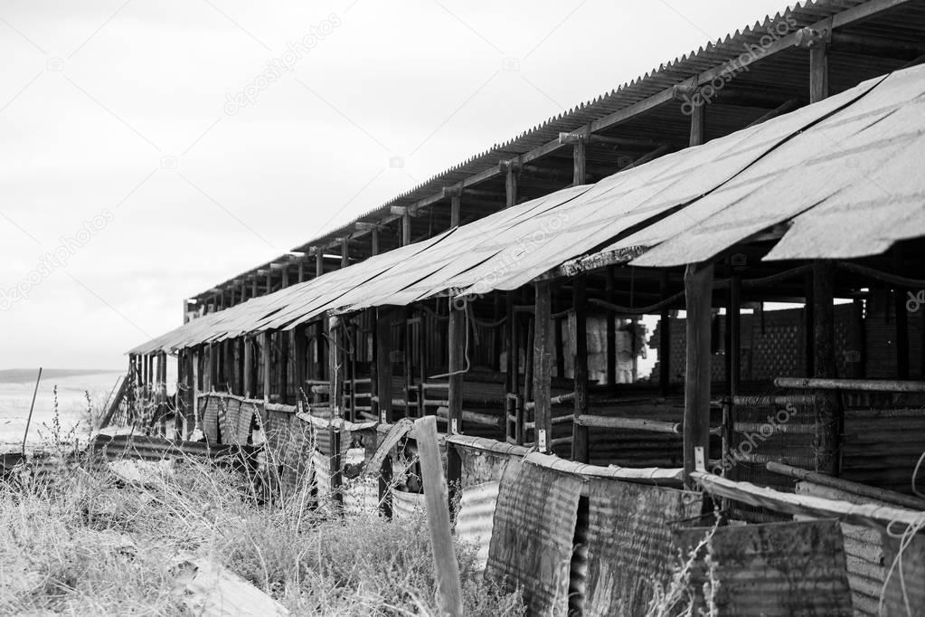 Wide angle view of old buildings and farm instruments on an old 