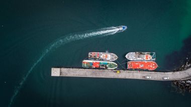 fishing vessels laying at anchor in the harbor clipart