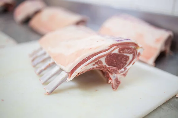 lamb ribs being sawed in a butchery