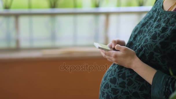 Gravid kvinna som använder smarttelefon — Stockvideo