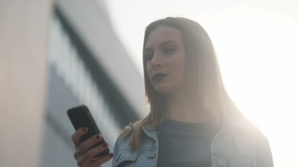 Woman using smartphone outdoor — Stock Video