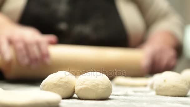 Woman flattening dough — Stock Video