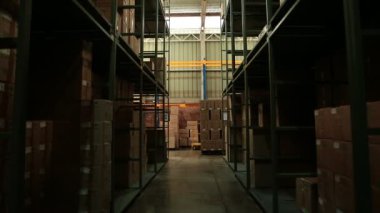 Bir işçi bir forklifti kutularını taşımak için kullanır 