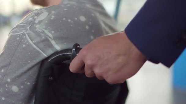 Man 's hands pushing a wheelchair — стоковое видео