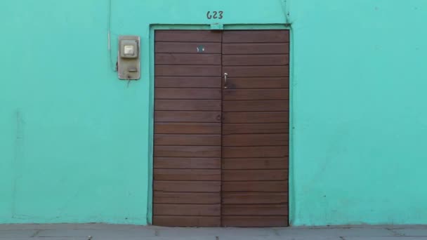 Door on colorful teal house — Stock Video