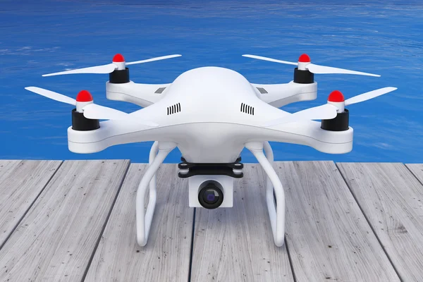 Drone Quadrocopter blanco con cámara fotográfica frente al océano. 3d —  Fotos de Stock