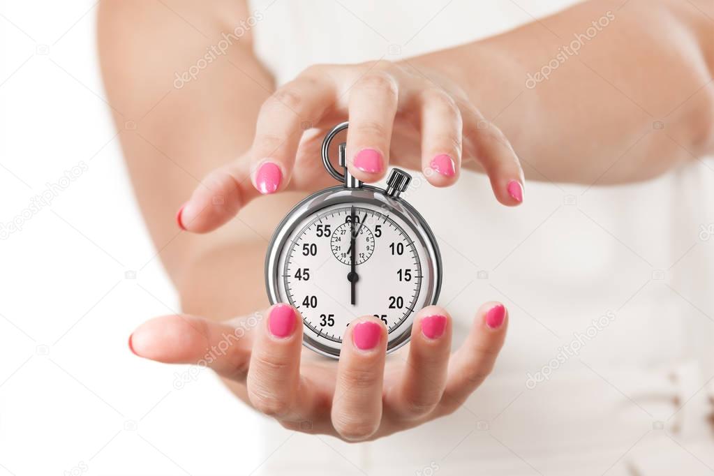 Save Time Concept. Two Woman Hands Protecting Stopwatch.