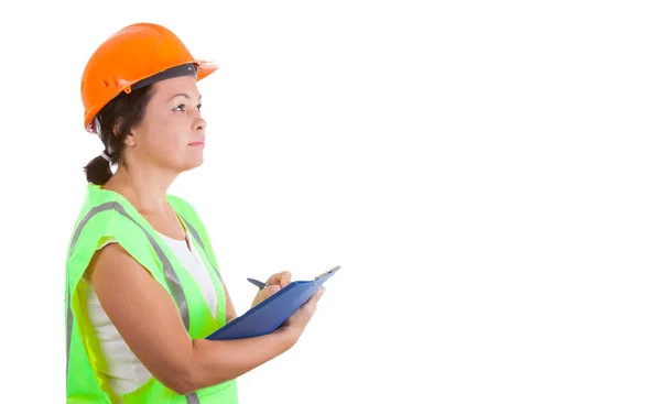 Attraktiv kvindelig arbejder i sikkerhedsjakke og gul hjelm holdi - Stock-foto