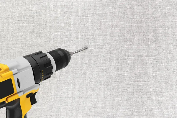 Yellow Rechargeable and Cordless Drill Drilling Hole in the Wall — Stock Photo, Image