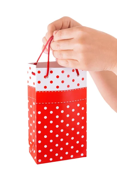 Vrouw Hand met rode Gift Bag met heden — Stockfoto