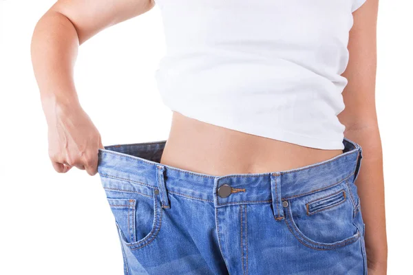 Kost-konceptet. Smala kvinnor i stora Jeans visar framgångsrika vikt — Stockfoto