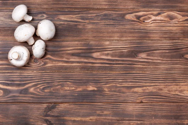 Champignon Mushrooms on Vintage Rustic Wooden Table Background