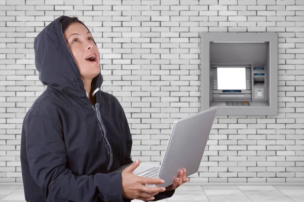 Criminal Woman Hacker Wearing Hood On Using a Laptop in front of — Stock Photo, Image