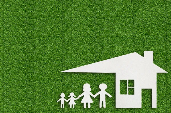 Paper cut of family on green grass