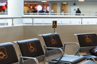 Sitting places for disabled person in airport or shopping center clipart