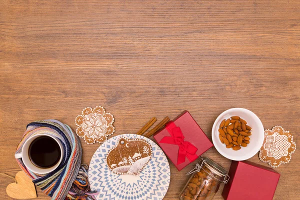 Almond, spice gingerbread, winter coffee and holidays red giftbox on the wood table