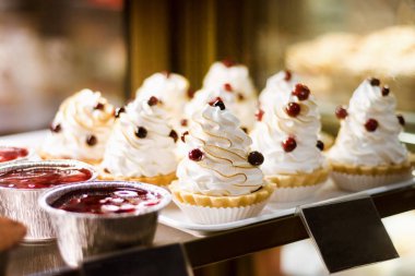 Pastanenin vitrininde kremalı ve meyveli tart kekleri.