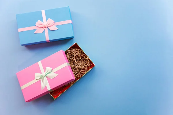 Holidays giftboxes packing on the pastel blue background for mother\'s day, christmas, birthday