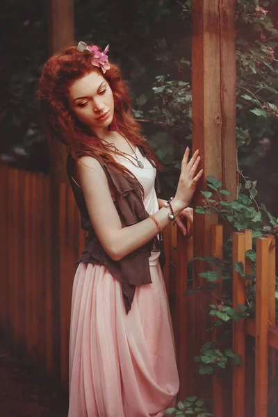 Red haired girl in the garden — Stock Photo, Image